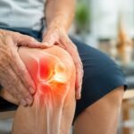 An older adult holding their knee, showing a glowing red area that indicates joint pain and inflammation typically associated with arthritis.