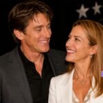 Craig Ferguson smiling with a female partner on the red carpet with a text overlay asking Is She Anne Hogarth