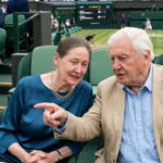 Sir David Attenborough and his daughter Susan Attenborough sitting together and talking in the Royal Box at the Wimbledon Tennis Championships.