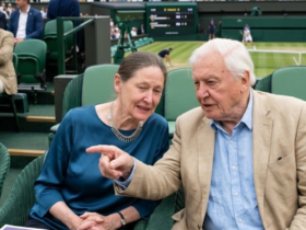 Sir David Attenborough and his daughter Susan Attenborough sitting together and talking in the Royal Box at the Wimbledon Tennis Championships.