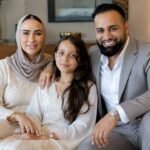 Emily Abraham and Adam Abraham, founders of Love Luxury, sitting with their daughter Maali "Moo" Abraham.