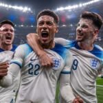 Jude Bellingham and his England national team teammates celebrating a dramatic victory during the FIFA World Cup knockout stages.