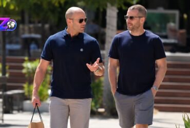 Hollywood actor Jason Statham walking and talking alongside a man in a casual outdoor setting.