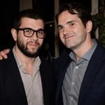 British comedian Jimmy Carr smiling alongside his Brother Colin Carr at a public event.