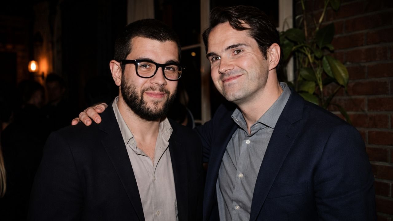 British comedian Jimmy Carr smiling alongside his Brother Colin Carr at a public event.