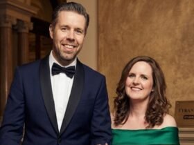 Paddy Considine and his wife Shelley Considine standing together in formal attire.