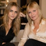 Cara Delevingne and her mother Pandora Delevingne sitting together on a sofa.