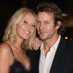 British businessman Robie Uniacke posing closely with his partner, actress Lady Emma Howard , at a public evening event.