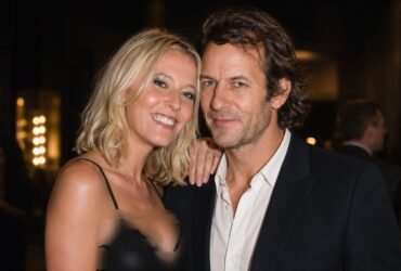 British businessman Robie Uniacke posing closely with his partner, actress Lady Emma Howard , at a public evening event.