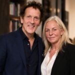 Monty Don and his wife Sarah Don standing together and smiling at an event.