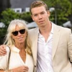 Actor Will Poulter standing outdoors next to his mother, Caroline Poulter, who is wearing sunglasses and a light-colored blouse.