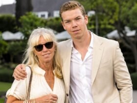 Actor Will Poulter standing outdoors next to his mother, Caroline Poulter, who is wearing sunglasses and a light-colored blouse.